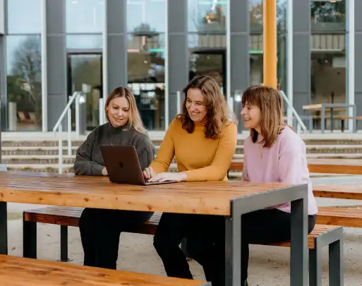 The famille team sitting at a desk, working together at a laptop