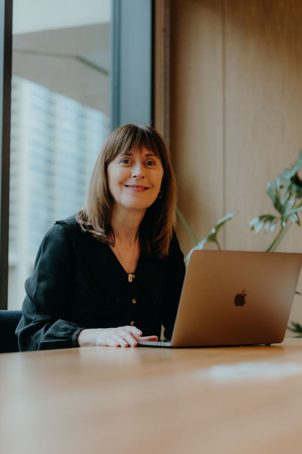 Debbie sitting at a desk