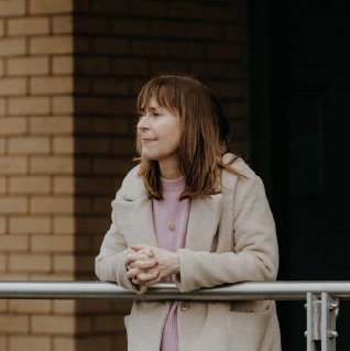 Debbie standing looking into the distance