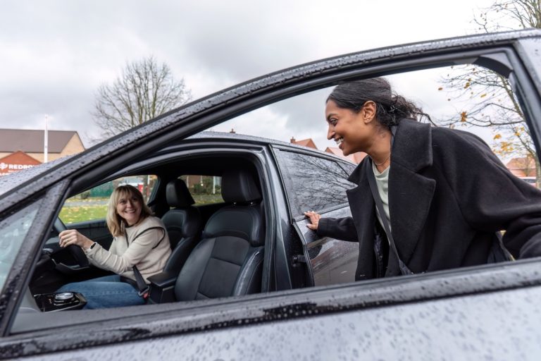 Liftshare. An image of two people sharing a car